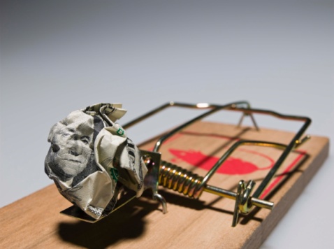 a mousetrap, baited with a wadded up dollar bill