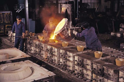 workers pouring molten steel in a factory