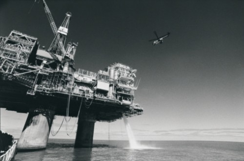 A black and white photo of an offshore oil drilling platform