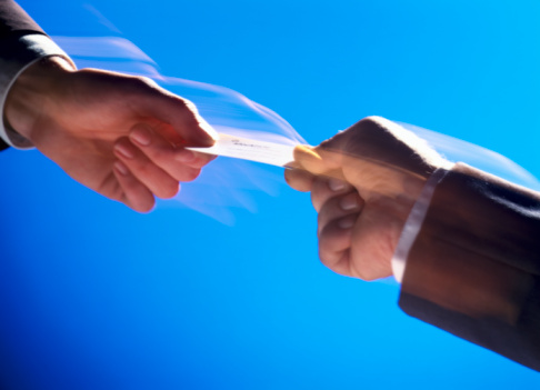 two hands in a tug of war with a credit card