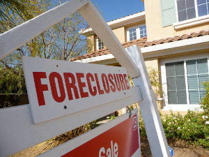 Close-up of the foreboding sign in front of a foreclosure property.