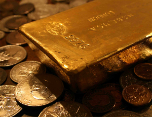Gold bullion and coins arranged for the camera.