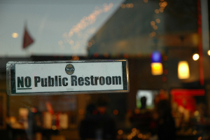 Sign on the door of a coffee shop that reads, “No public restroom.”