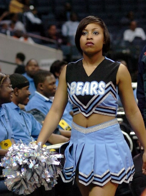 student_loan_default A college cheerleader in uniform walks the court as she stares into space, apparently deep in thought.