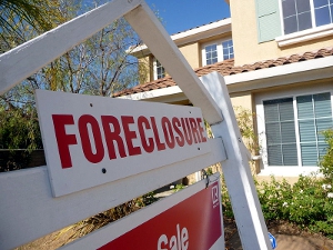 Close-up of a foreclosure sign outside a home property.