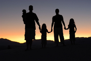 Sunset photo of a family at White Sands, New Mexico.