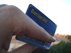 Close-up of a Barclaycard credit card in someone's hand.