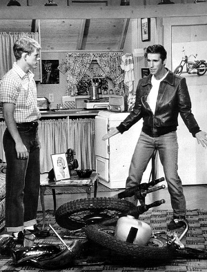 Publicity photo from Happy Days. Pictured are Richie (Ron Howard) and Fonzie (Henry Winkler) at Fonzie's apartment over the Cunningham's garage. The episode deals with Fonzie's destroyed motorcycle.