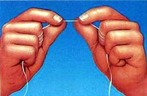 dental_floss Two hands holding a strand of dental floss.