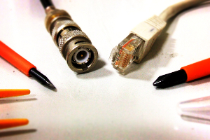cable_tv Coaxial cable and networking cable ends displayed on a desktop next to various screwdrivers.