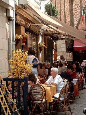People dining at an outdoor European restaurant.