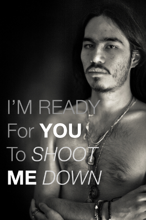 Photo of a shirtless man. Text on the image reads, “I'm ready for you to shoot me down.”