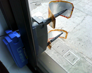 wifi Example of a wireless router with cut beer cans attached to the antenna to boost the Wi-Fi signal.