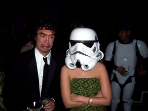 A man and his female roommate, who is wearing a Star Wars stormtrooper helmet.