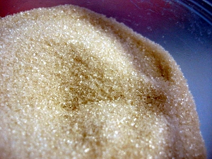 Close-up of a bowl of raw, unrefined sugar.