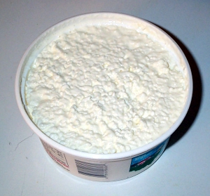 An open container of cottage cheese.