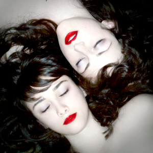 Facial close-up of two young women sleeping.