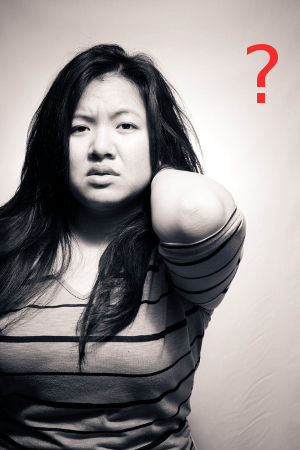 Black and white photo of a young Asian woman looking somewhat confused. Perhaps she's wondering how to give non-cliched holiday gifts?