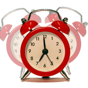 A ringing red alarm clock.