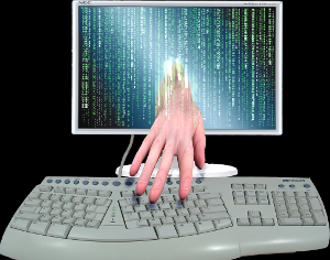 A hand reaching out from a computer screen to type on a keyboard.