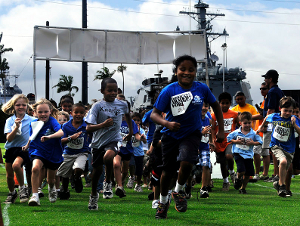 Children from the Morale, Welfare and Recreation (MWR) Youth Sports Program at Commander, Navy Region Hawaii, participate in a 1.5-mile fun run around Ward Field at Joint Base Pearl Harbor-Hickam. (U.S. Navy photo by Mass Communication Specialist 2nd Class Mark Logico/Released).