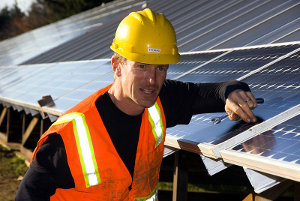 A worker checks to the alignment of a solar panel prior to installation. Nov. 26, 2008.