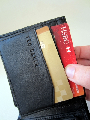 An image of someone taking out their credit card from their wallet.